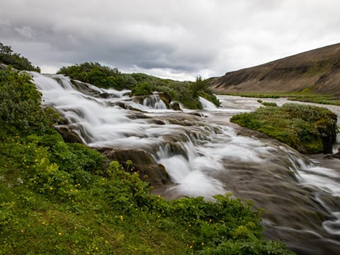 Fossabrekkur, a lesser-known gem where crystal-clear streams tumble through mossy fields