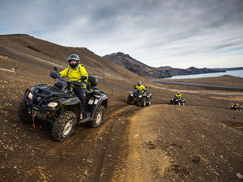 ATVs driving up a mountain side