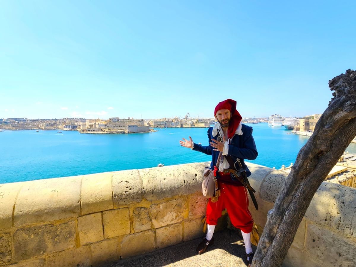 Captain , with the Grand Harbour in the background, uncovers stories from Valletta's past