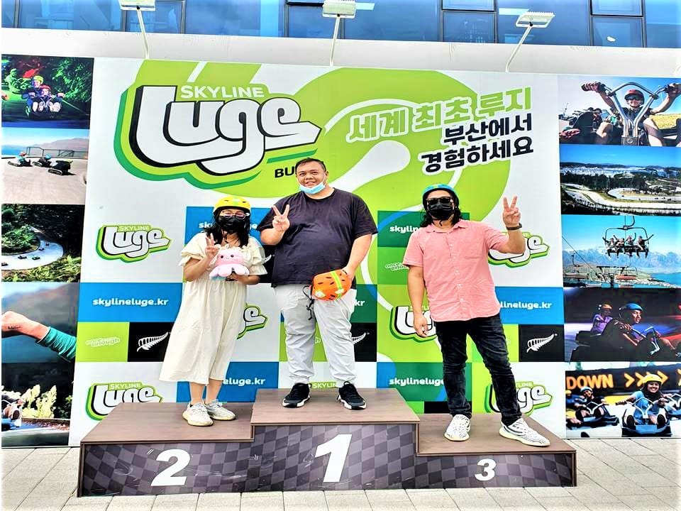 Celebrating the ride at the Skyline Luge finish area on the 1st, 2nd, and 3rd place podium.