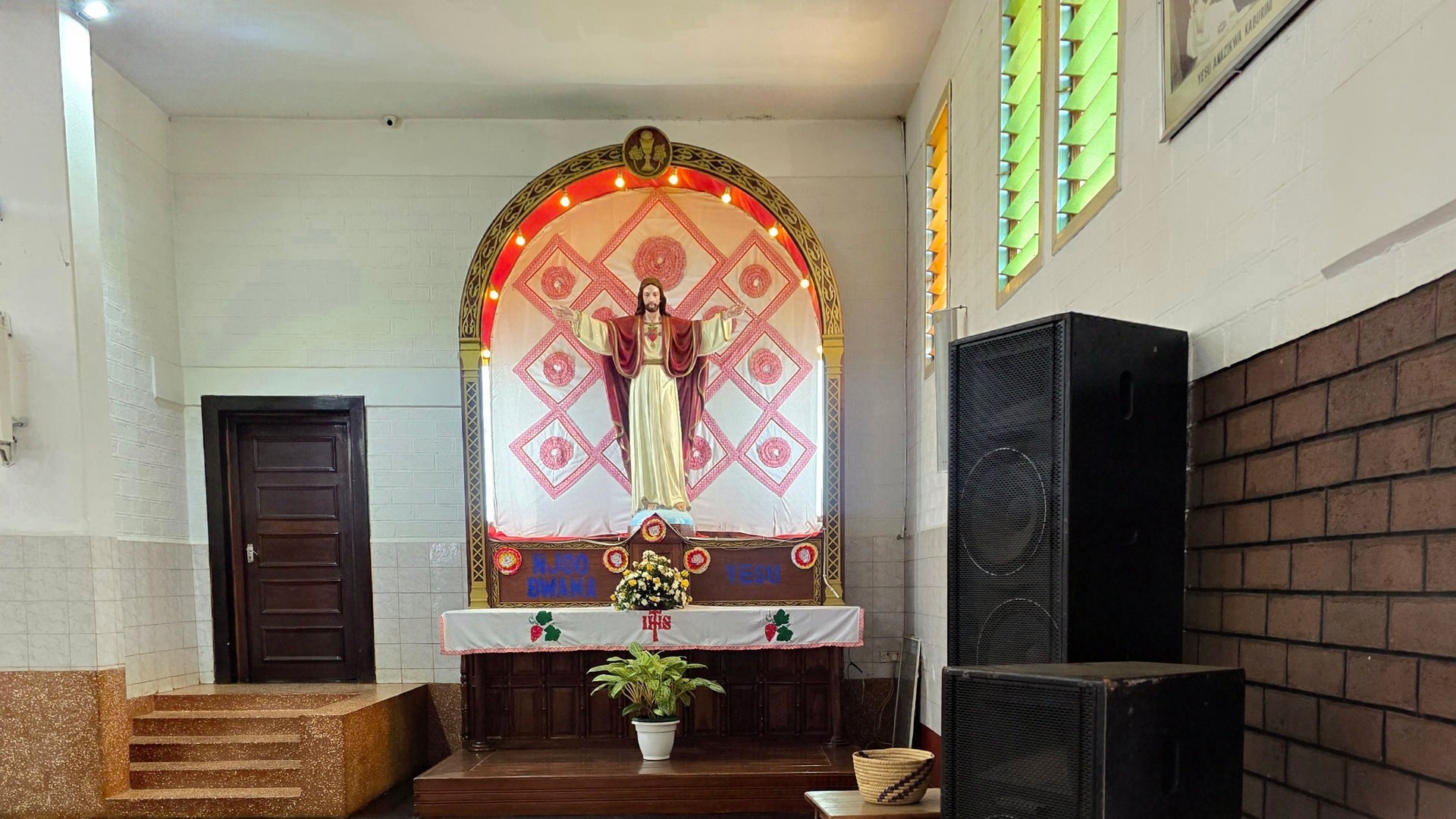 Inside view of Christ the King Cathedral featuring an ornate altar and stained-glass details.