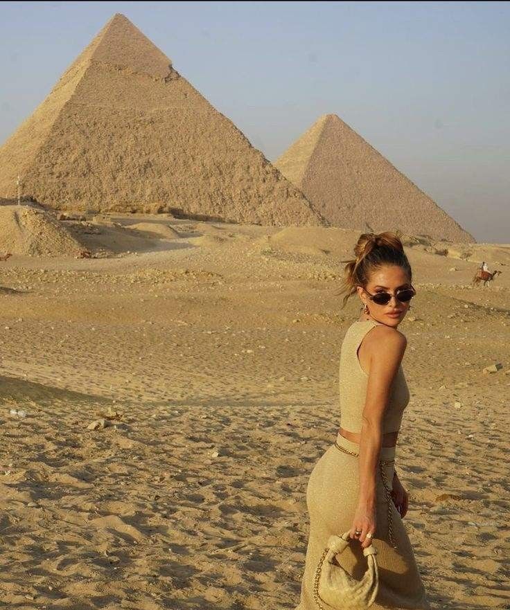 Panoramic view of the Great Pyramids of Giza and the Sphinx under the bright Cairo sky.