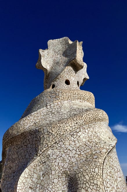 A sculpture covered with white broken tiles - in the background the blue sky