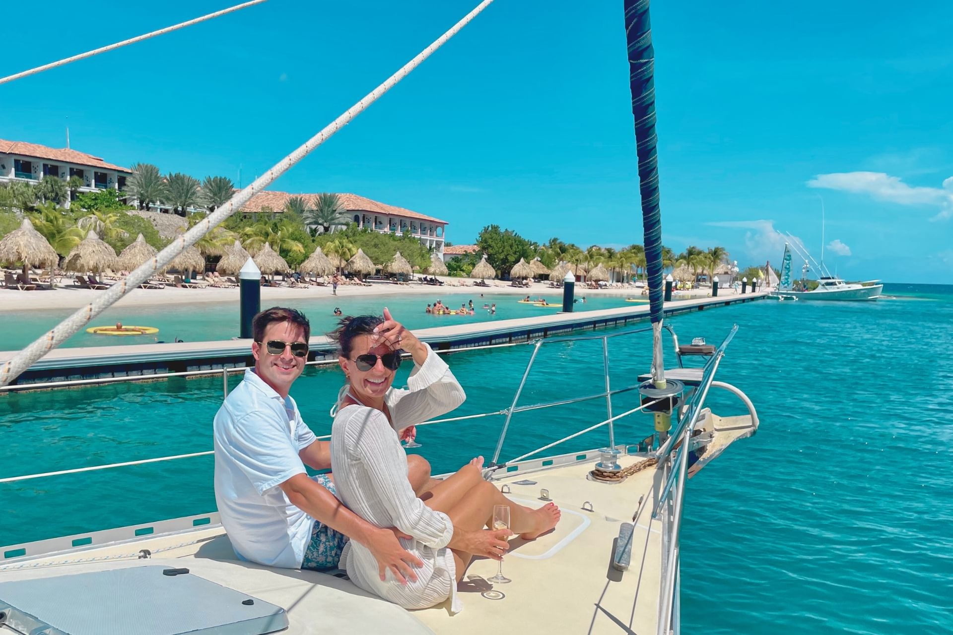 Happy couple sailing along St Barbara Beach on a day tour onboard sailing yacht in Curacao