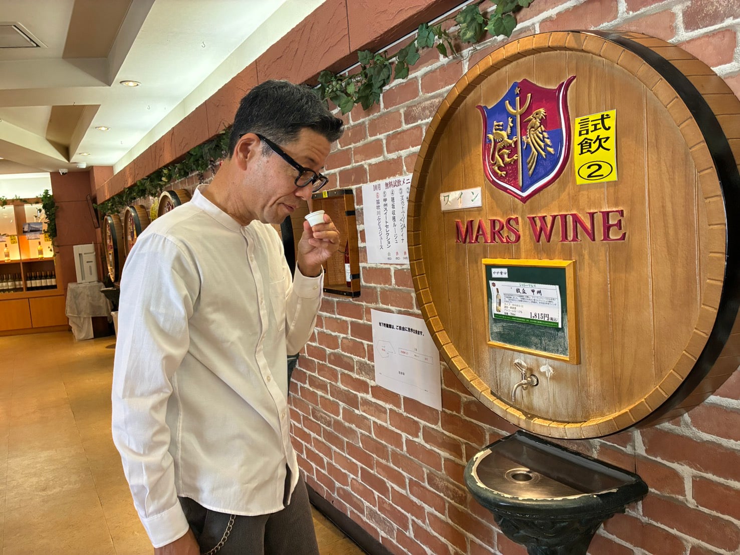 A visitor selecting and tasting local wines at a winery dispenser
