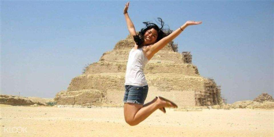 Panoramic view of the Great Pyramids of Giza and the Sphinx under the bright Cairo sky.