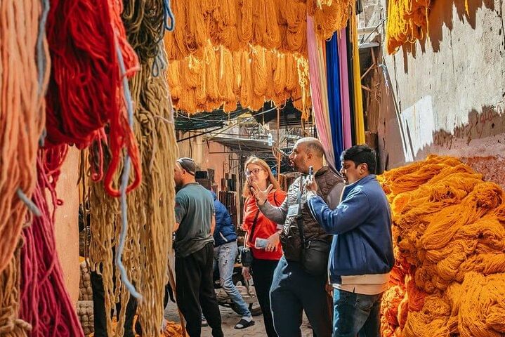 A snapshot of Marrakech shopping tour magic: traditional leather goods and colorful slippers displayed in the bustling local markets, where every detail tells a story of Moroccan heritage.
