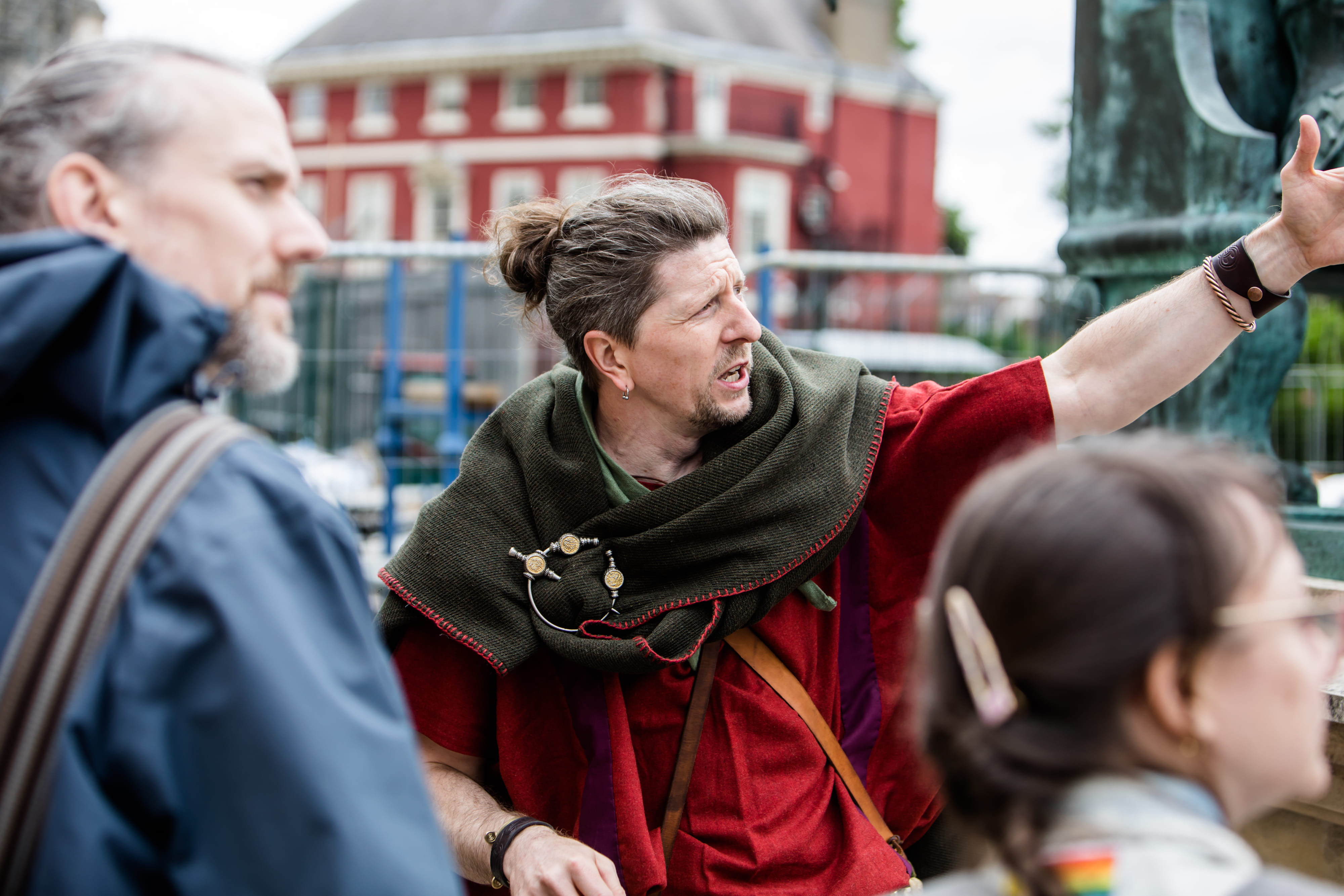 A Roman legionary stands besides the statue of Constantine the Great, besides York Minster, with his crowd gathered around.