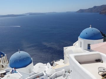 Iconic blue domes and breathtaking caldera views - the Santorini you came to see, captured at the perfect spot.