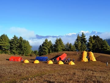 Trekkers pitch their tents in an open field in Jantardhap. Numbur mountain stands tall in the background. Image Credit: The Kathmandu Post