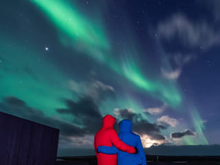 A couple in love looking at the Northern Lights in Iceland