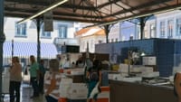 Inside of Aveiro Fish Market with seafood stalls, fish boxes, workers, and visitors
