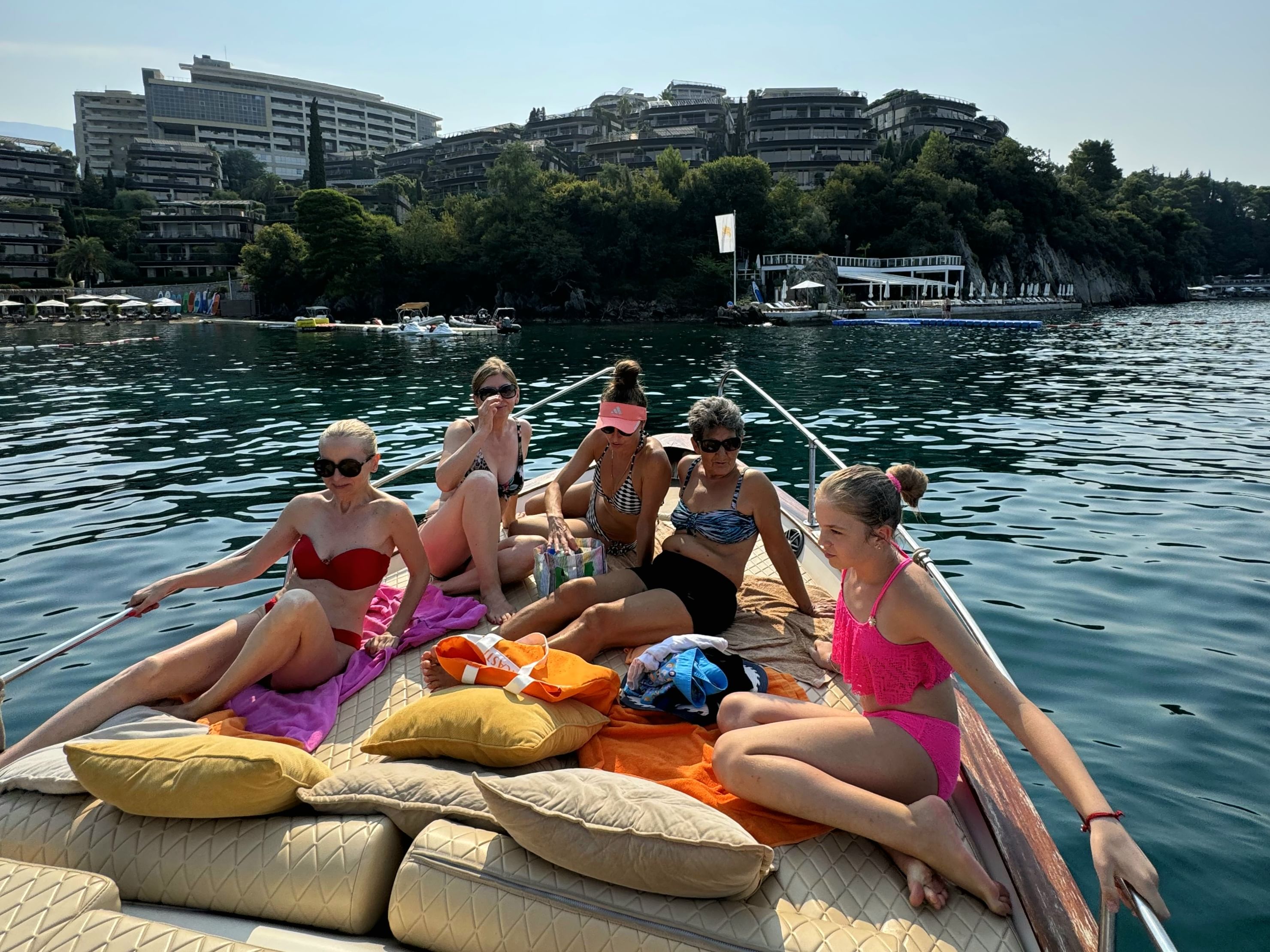 A family capturing memories together as they pose for a photo on the bow of the boat.