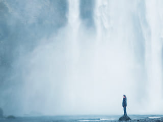 Feeling the power from dropping waters of Skógarfoss waterfall Iceland
