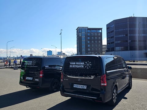 Two parked vans with the "Your Friend in Reykjavik" logo on the back window.