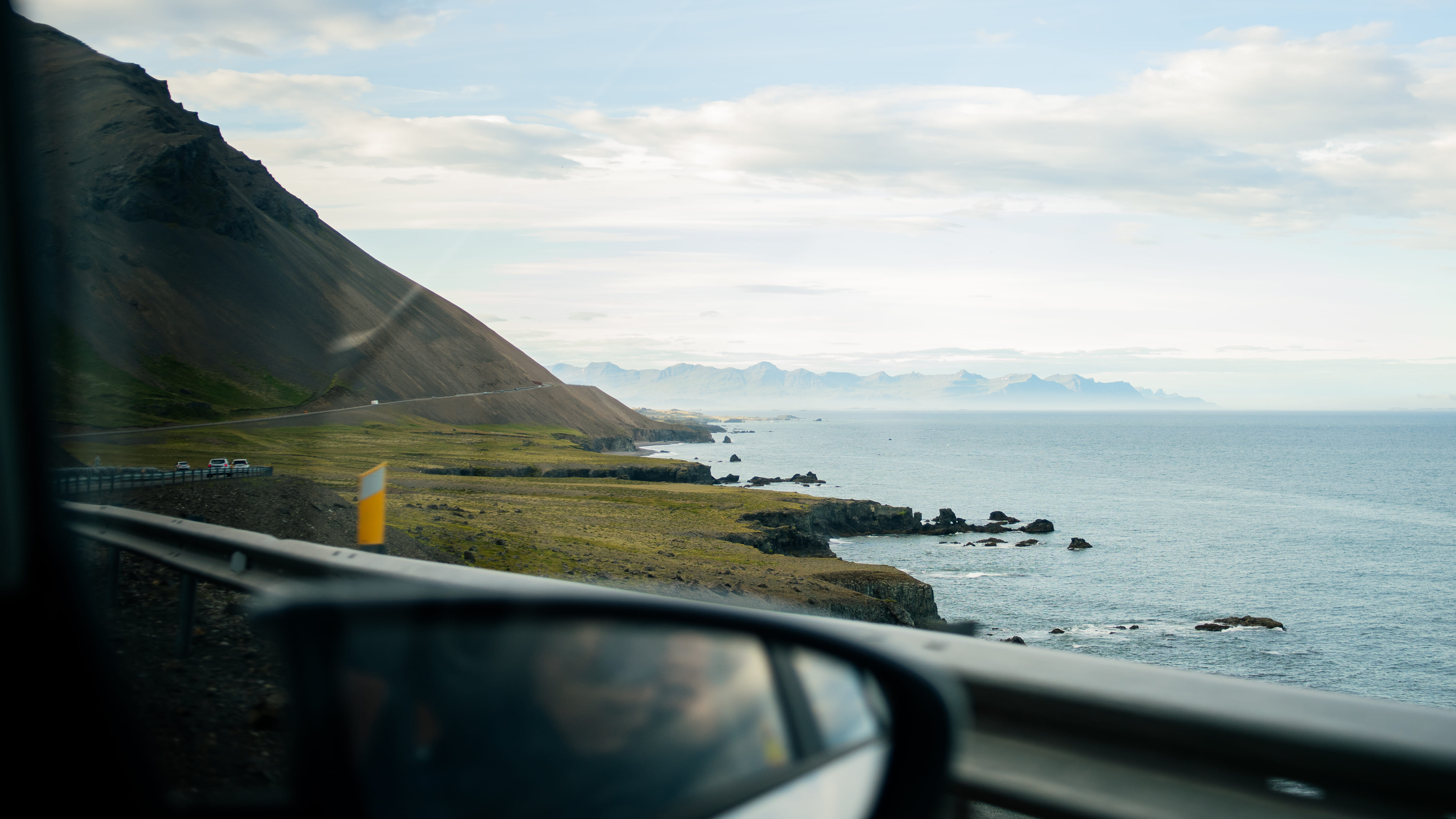 Scenic coastal view seen from the window of a premium executive vehicle during a private tour