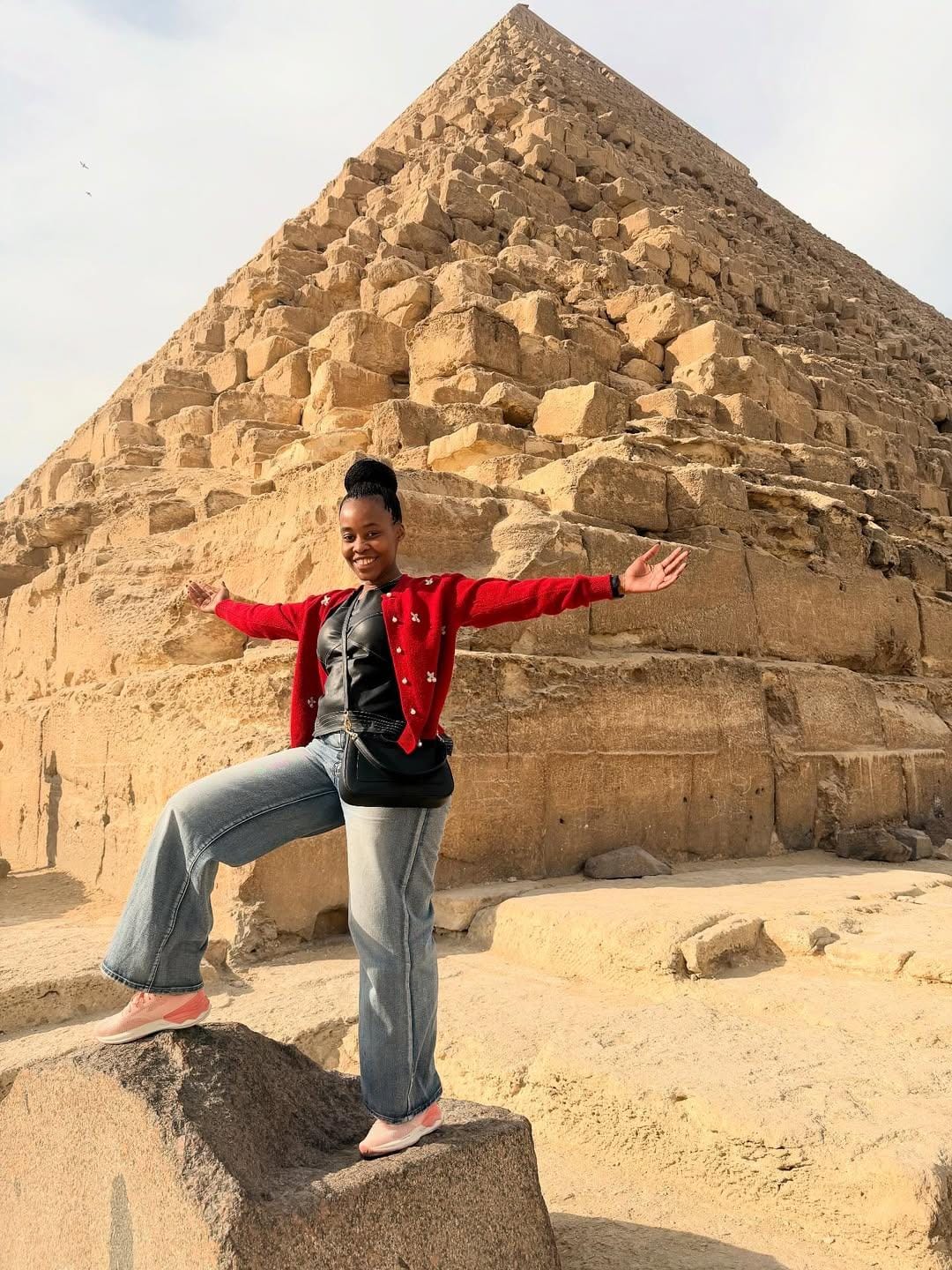 Visitor exploring Khufu Pyramid, capturing pyramid photography Egypt.