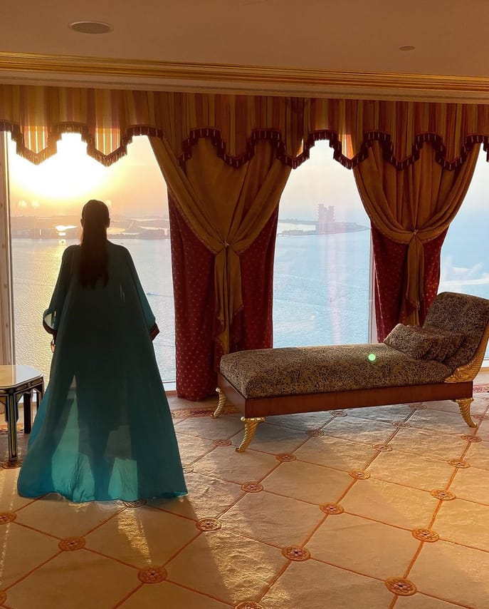 "Twilight charm: The Burj Al Arab's silhouette against the setting sun."