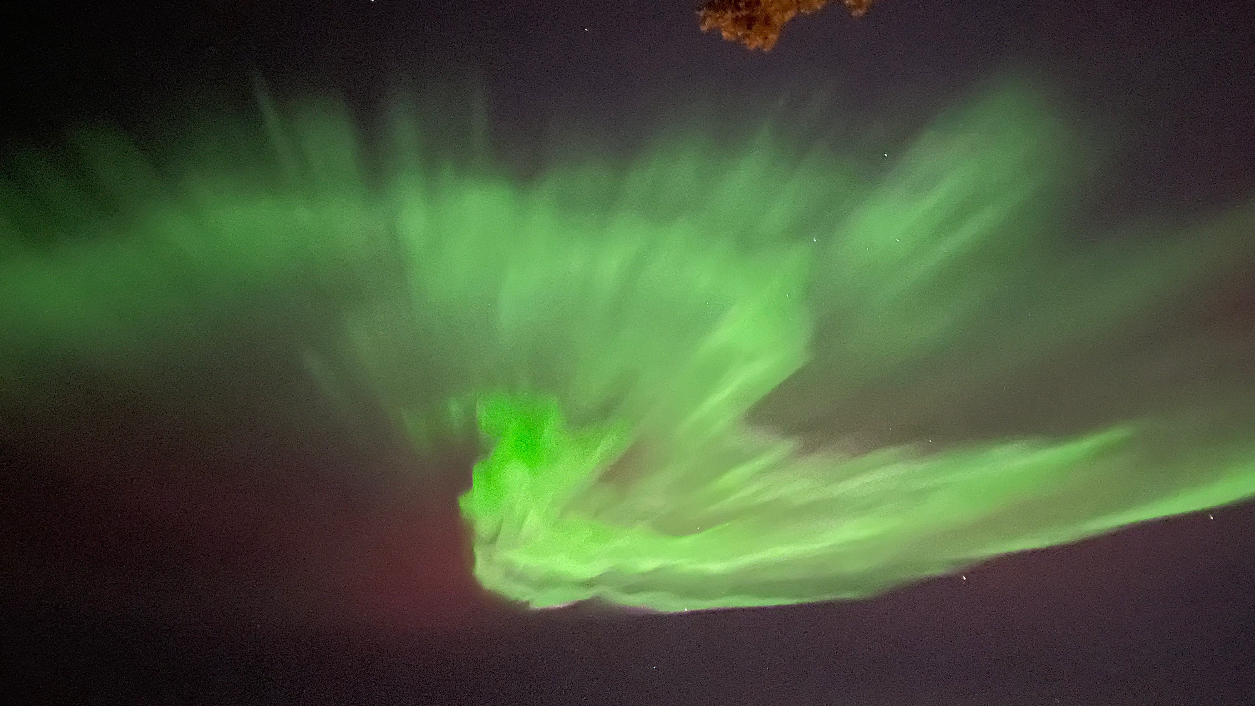 Bright aurora bands visible high above Lapland.