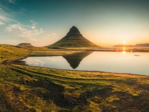 The sun rises, or sets, who knows, behind Kirkjufell Mountain:)