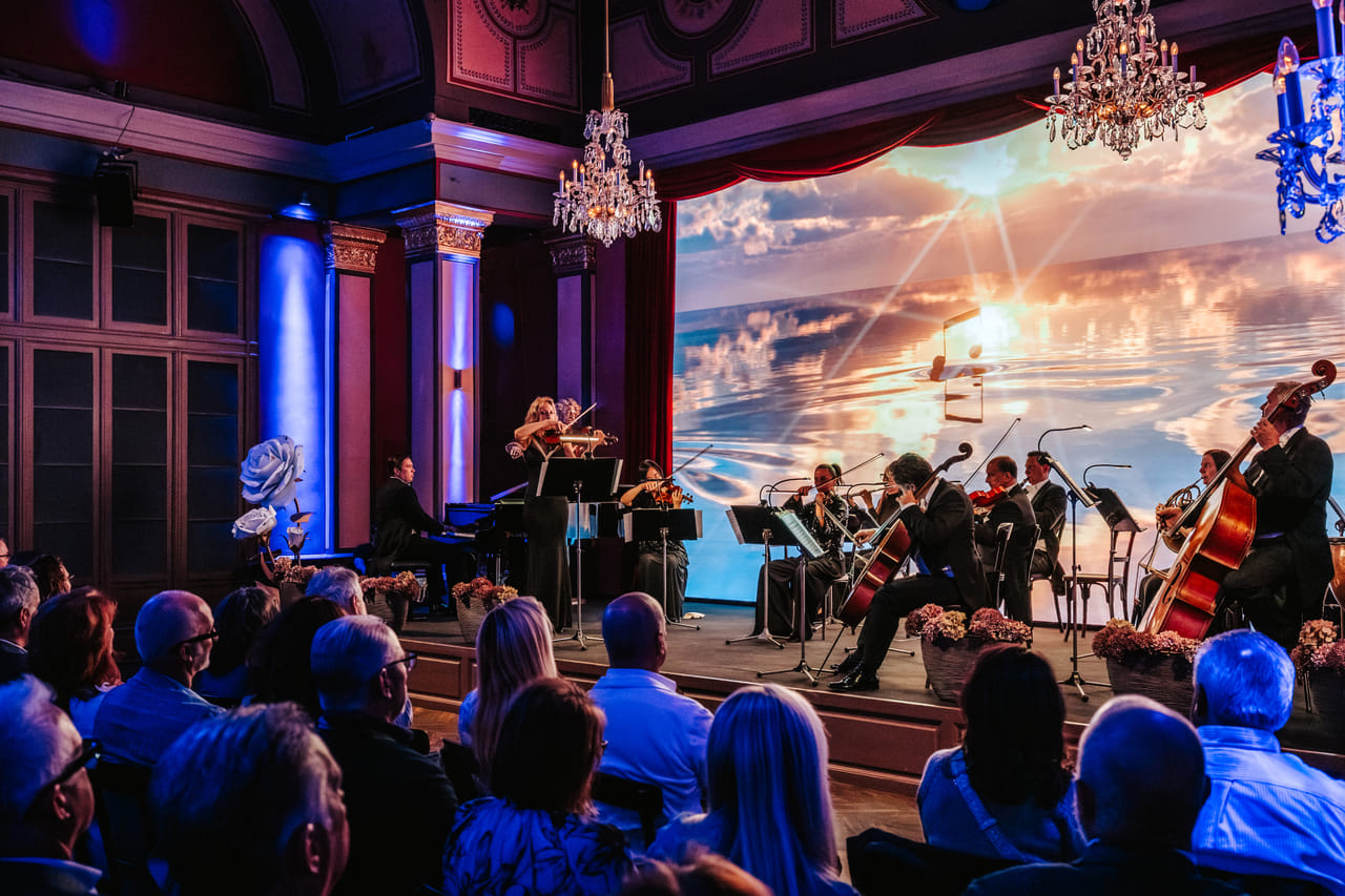 Live classical concert Vienna featuring orchestra with multimedia ballet projection and full audience