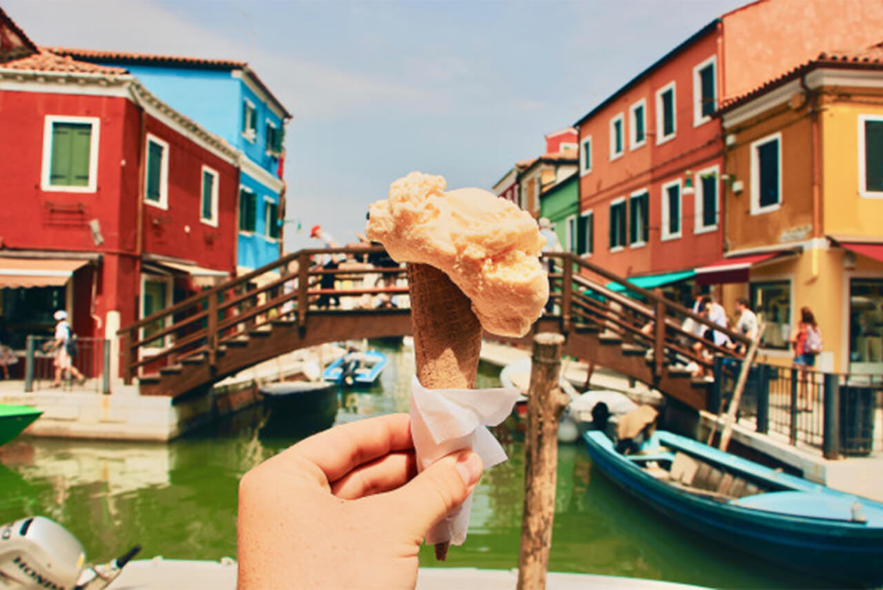 Burano bridge with colorful houses and gelato, Venice lagoon Italy