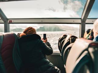 Guest sitting in Monster Truck with panoramic view over the glacier