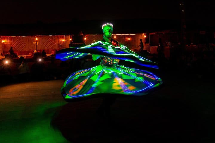 Colorful Tanoura dancer spins around during a show at a desert camp near Dubai.