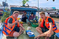 Enjoying sweet pineapple on a boat, at Cai Rang floating market