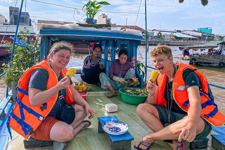 Enjoying sweet pineapple on a boat, at Cai Rang floating market