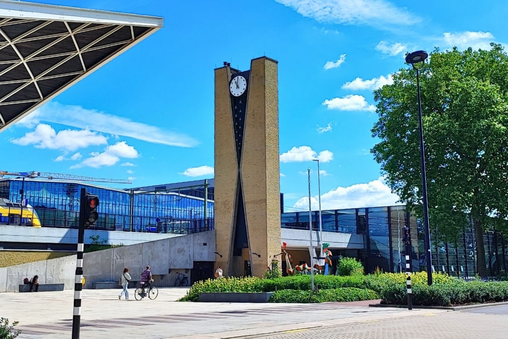 Street view of Tilburg Centraal train station with the Wasknijper monument.