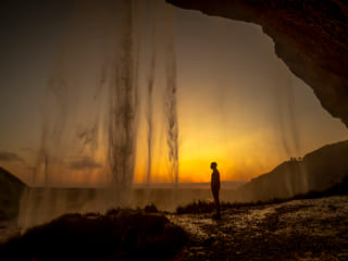 Gazing at the dropping waters at Seljalandsfoss waterfall