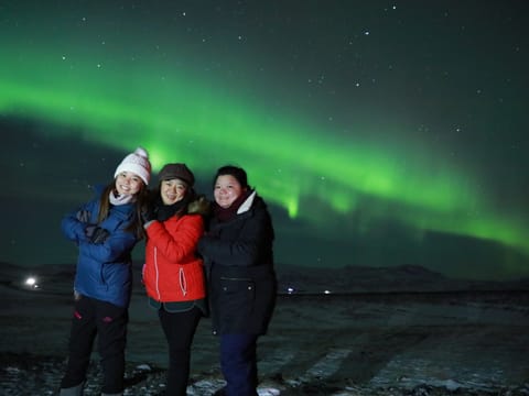 Family enjoying the Northern Lights Iceland