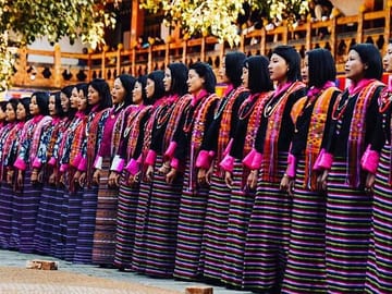 Bhutanese women in traditional costumes singing folk songs at one of the annual festivals