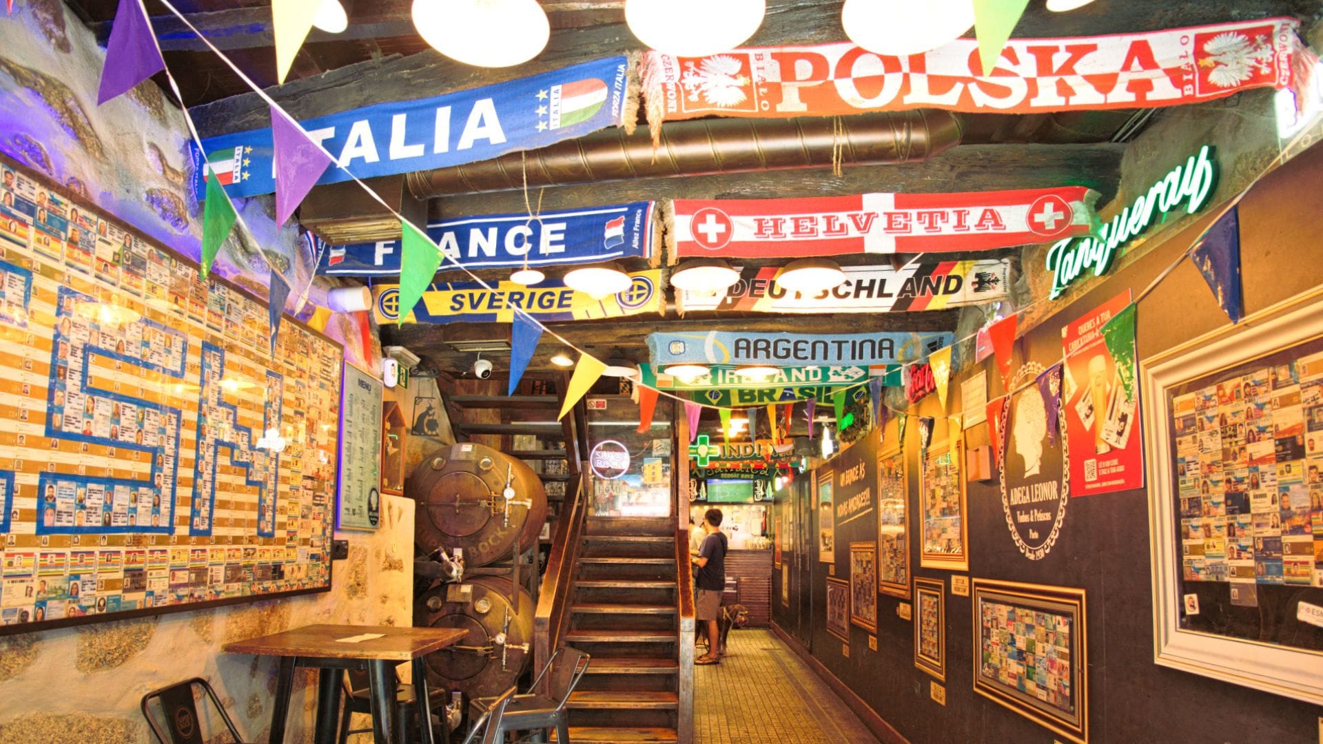 Vibrant interior of a traditional Porto tavern decorated with football scarves from around the world, part of a Cooltour Oporto food tour ro