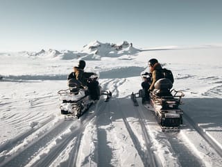 People riding on snowmobiles