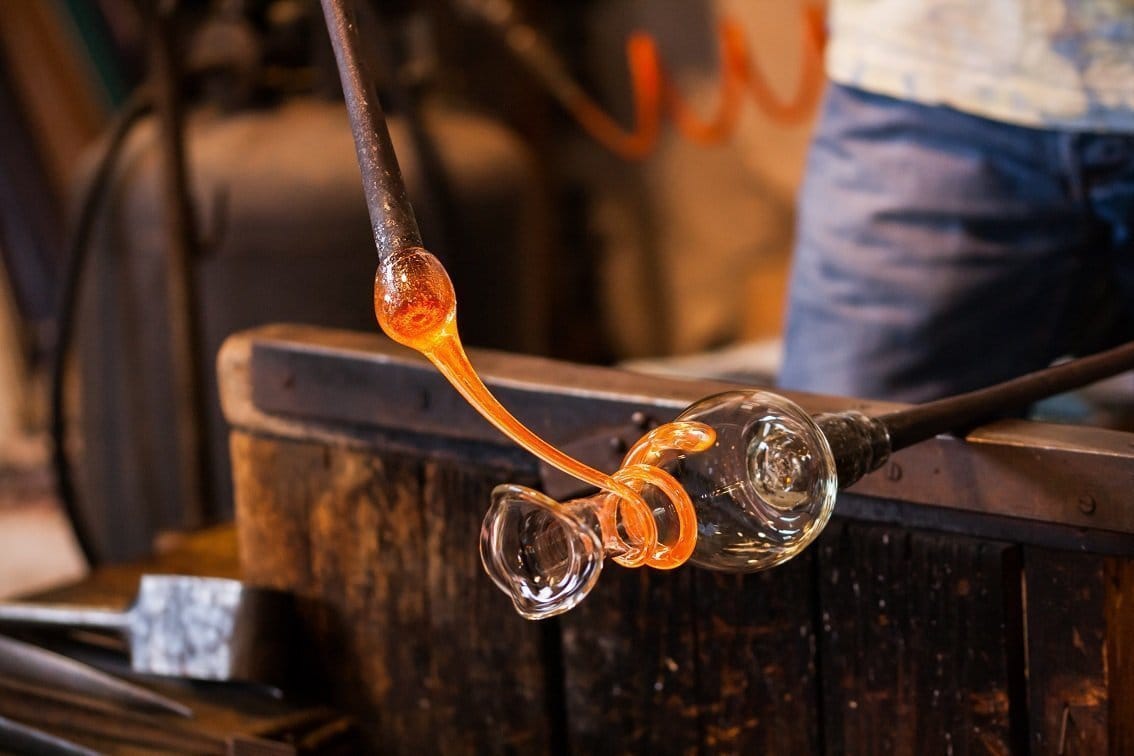 Artisan glass demonstration in Murano, Venice with colorful glass pieces