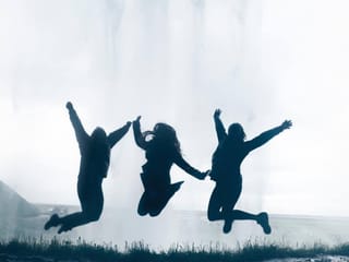 Jumping with joy behind Seljalandsfoss waterfall