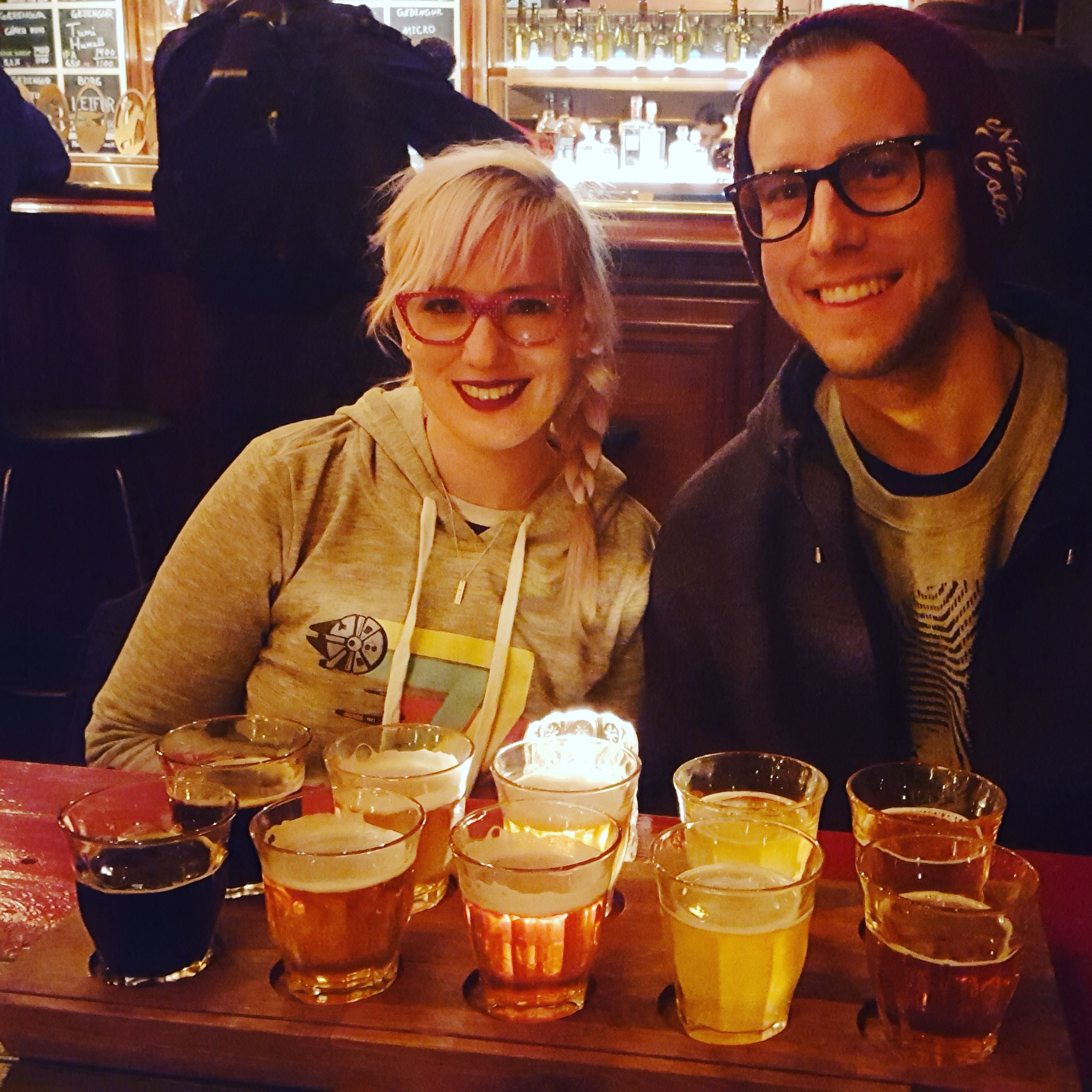 A couple smiling for the camera during a beer sampling