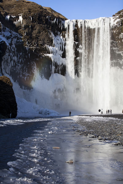 people admiring waterfall during Golden circle and south coast tour