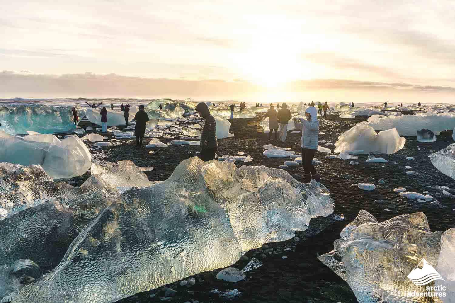 People wondering around and taking in diamond beach during 4 day tour Iceland