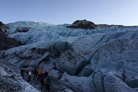 A group of people exploring glacier during Arctic adventures 2 day south coast tour