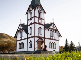 Húsavík church, a white church with people outside