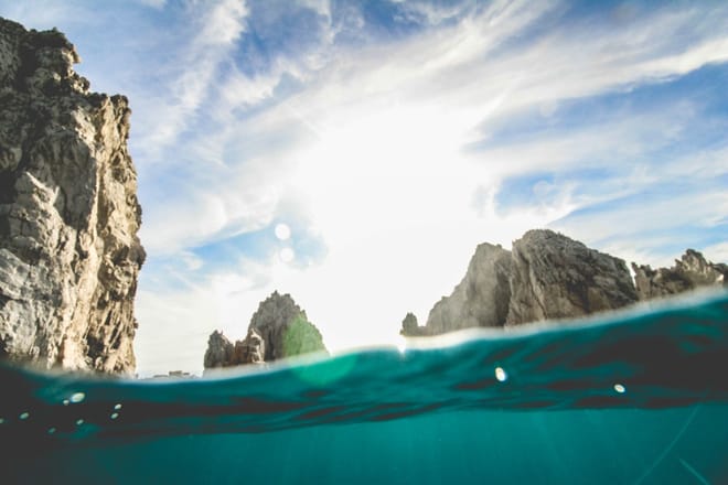 Split view waterline cabo san lucas arch lands end rock formations sea of cortez turquoise water los cabos