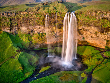 Seljandsfoss invites you to walk behind the waterfall and truly immerse yourself in the beautiful nature in Iceland