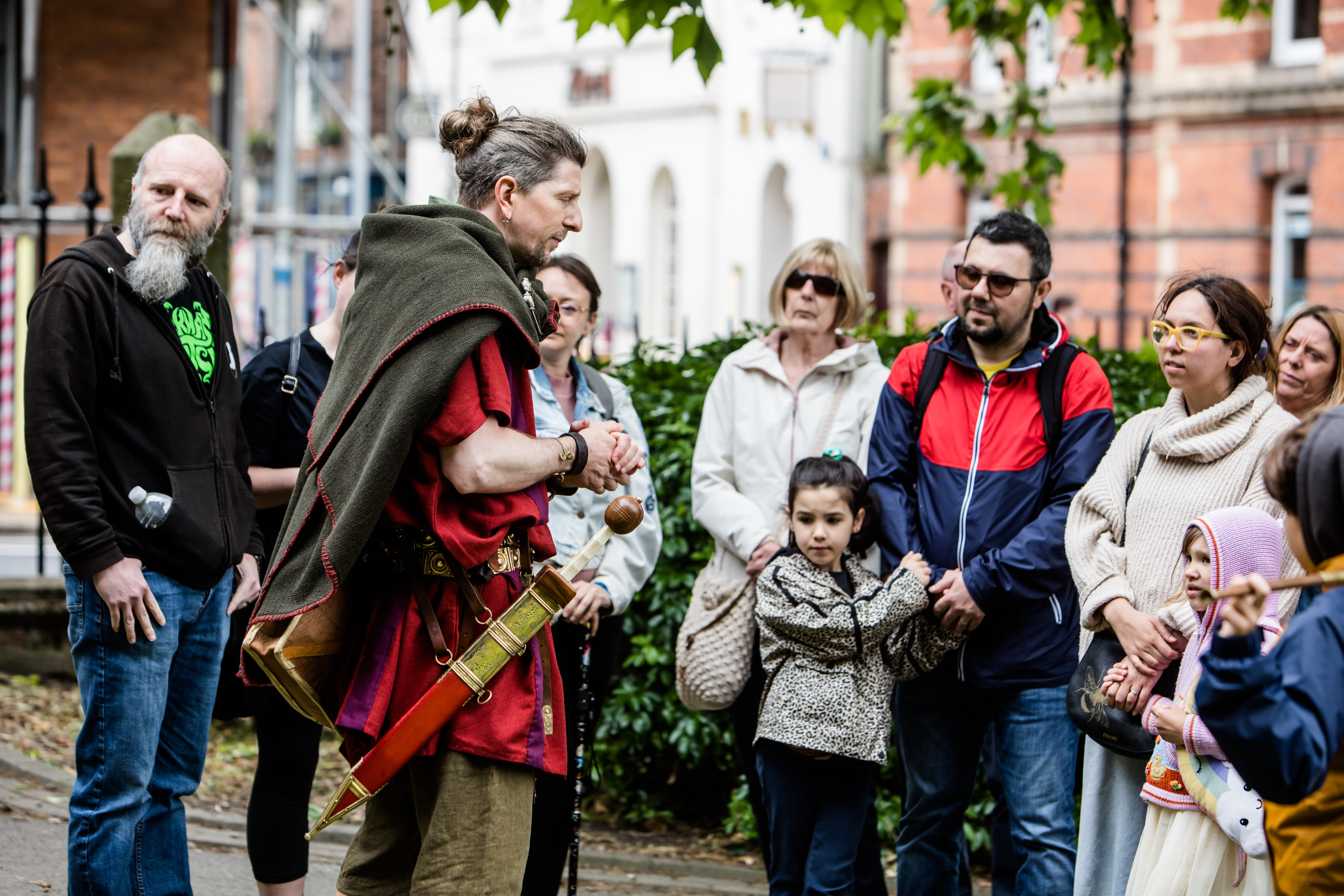 The Original Roman Walk's costumed guide is stood surrounded by guests just before starting the Roman tour of York.