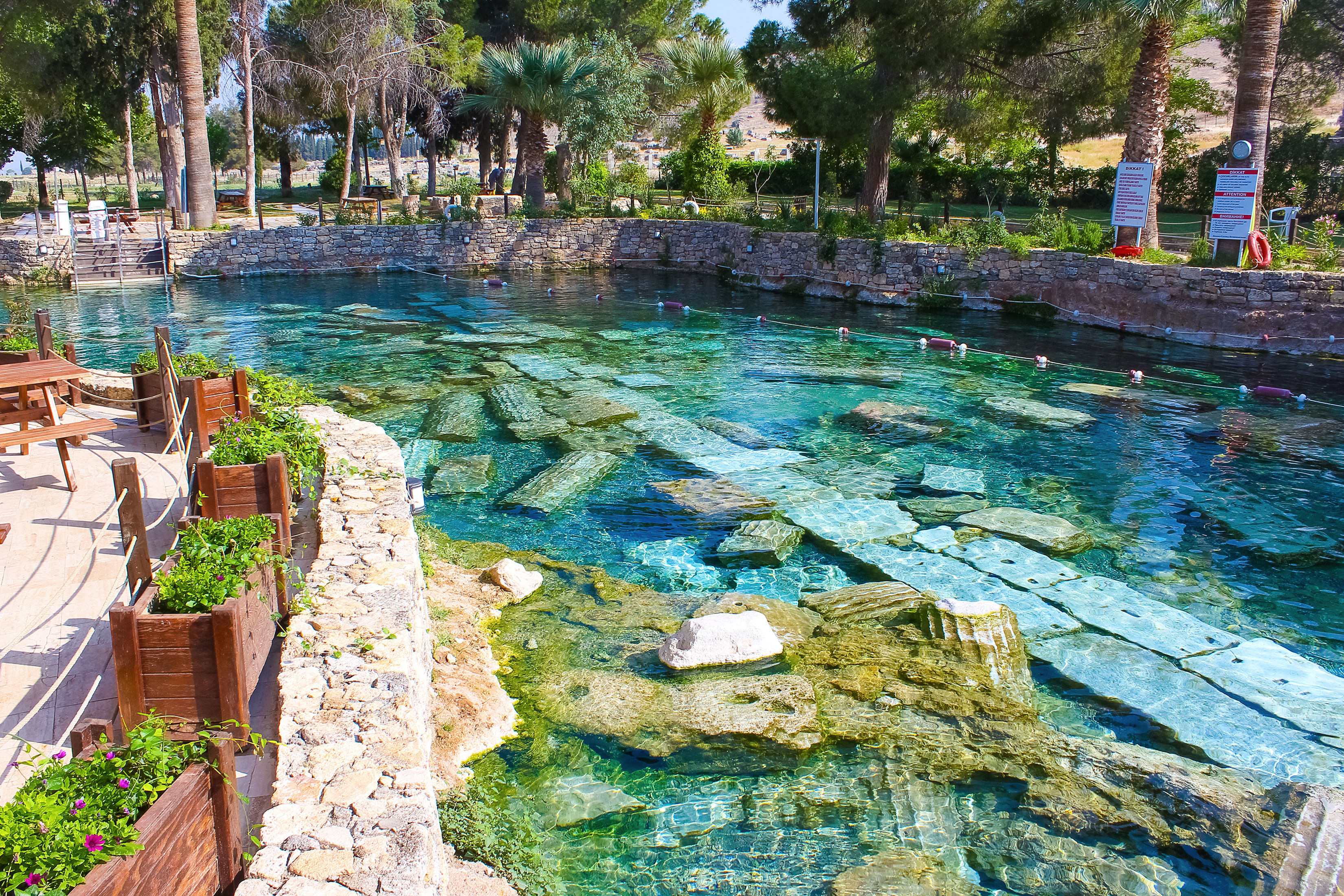 “Cleopatra Pool in Pamukkale, showing clear thermal water with ancient stone columns submerged beneath the surface.”