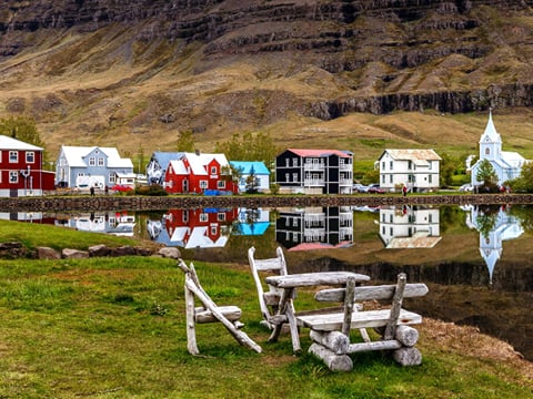 A shot of Seyðisfjörður with a white table set in the foreground.