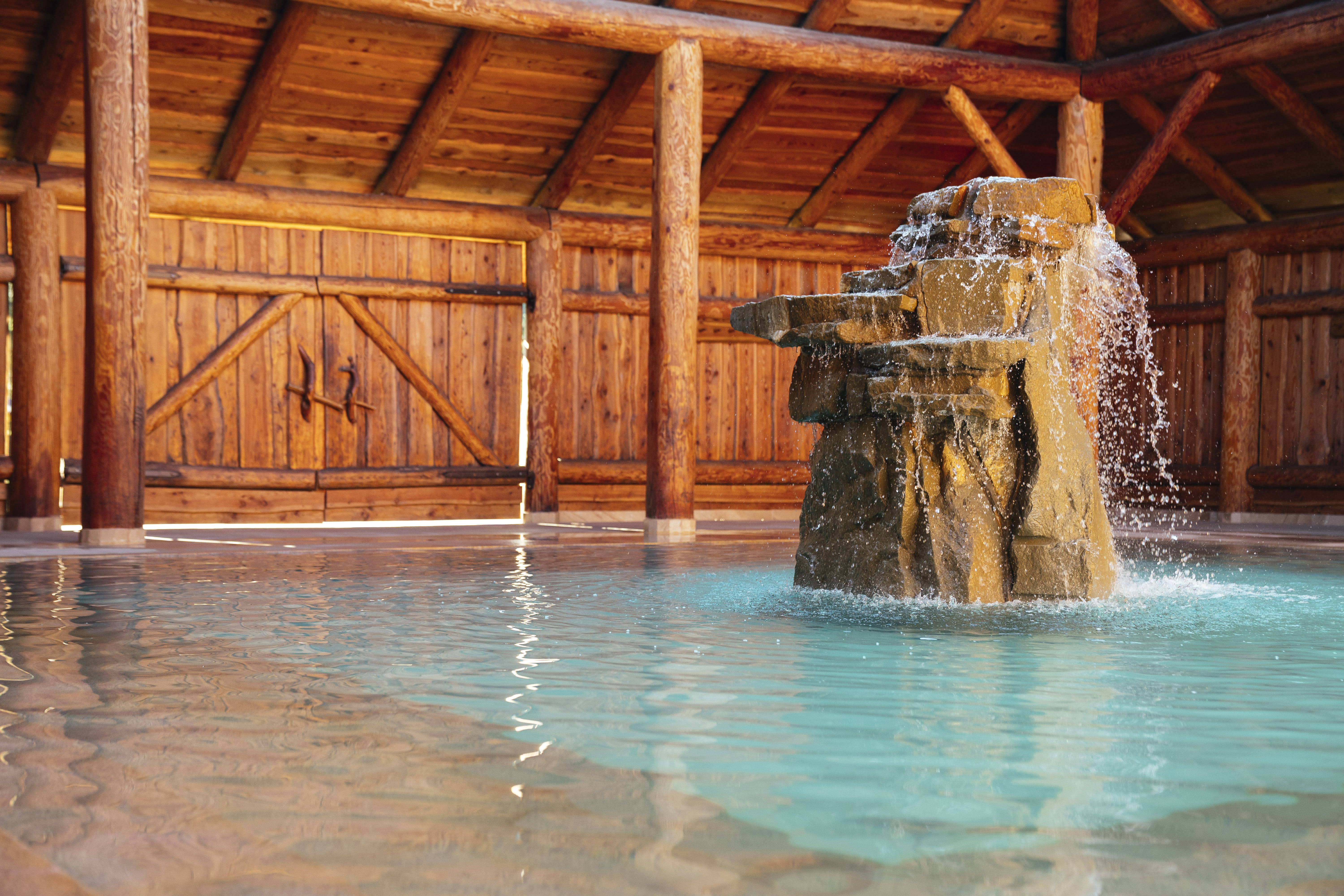 Gorący Potok indoor thermal pool with stone fountain — natural sulphur water Podhale