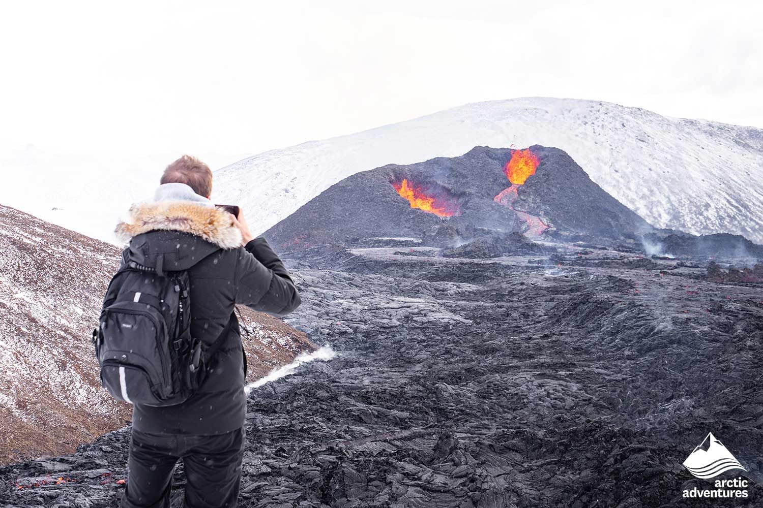 Taking picture of erupting volcano in Iceland during 4 day tour Iceland